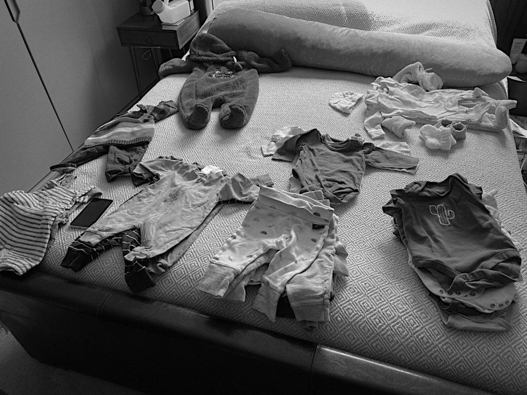Piles of baby clothes